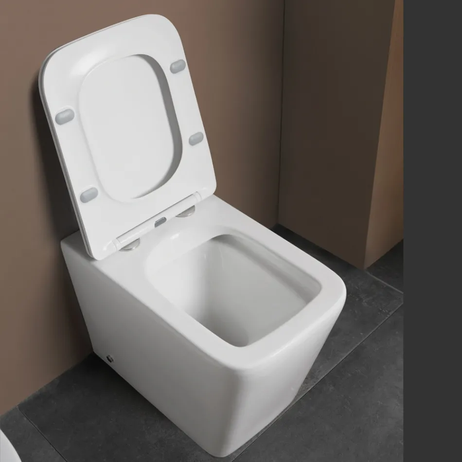 Gulvmonteret toilet med soft-close keramisk sæde og moderne design - Giunco Viadurini